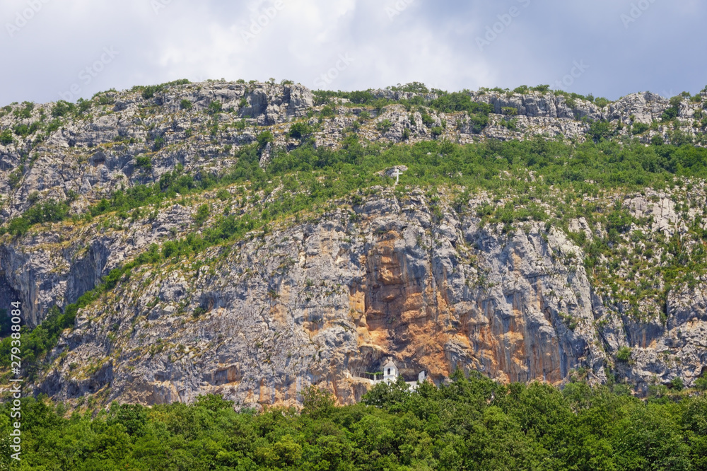 Mountain summer landscape. Montenegro, vertical mountainside of Ostroska Greda with Ostrog monastery