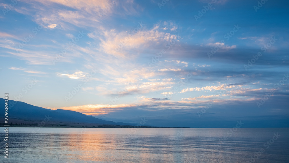 gentle sunset on the shore of a mountain lake Issyk Kul Kyrgyzstan