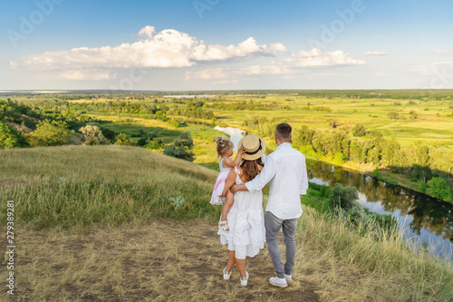 Family of three people looking to beautiful landscape