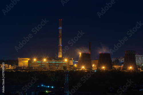 View of the working plant with pipes and yellow lights at night