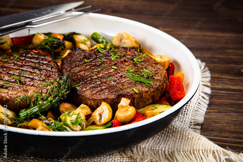 Grilled steak, baked potatoes and vegetables Grilled steak, baked potatoes and vegetables