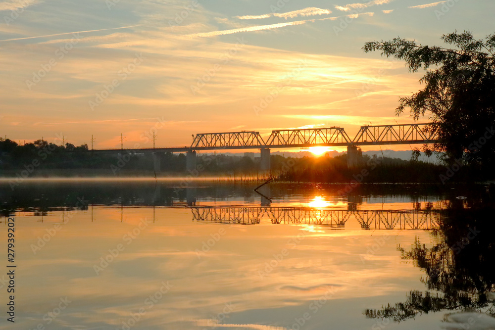 river sunrise railway bridge in the background