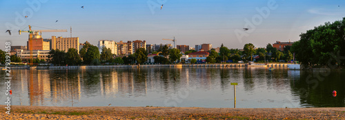 Panorama of the city beach on a warm evening. Beautiful river and sandy beach.