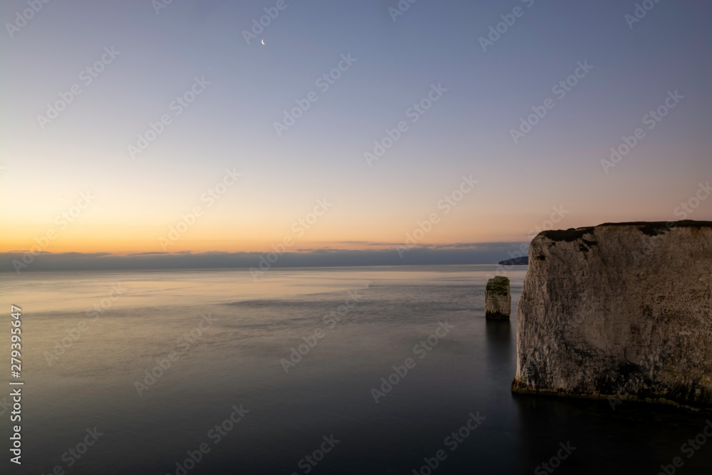Early sunrise at white cliffs of Jurassic Coast in South of England near Swanage