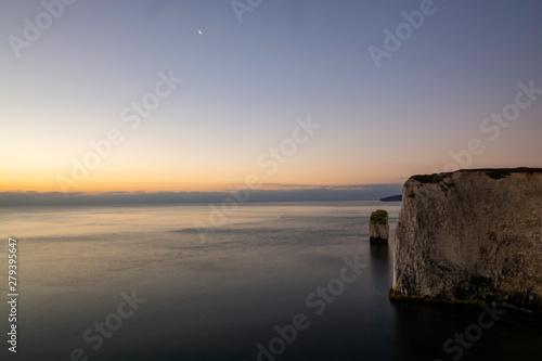 Early sunrise at white cliffs of Jurassic Coast in South of England near Swanage