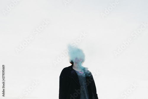 Girl with blue smoke around her face photo