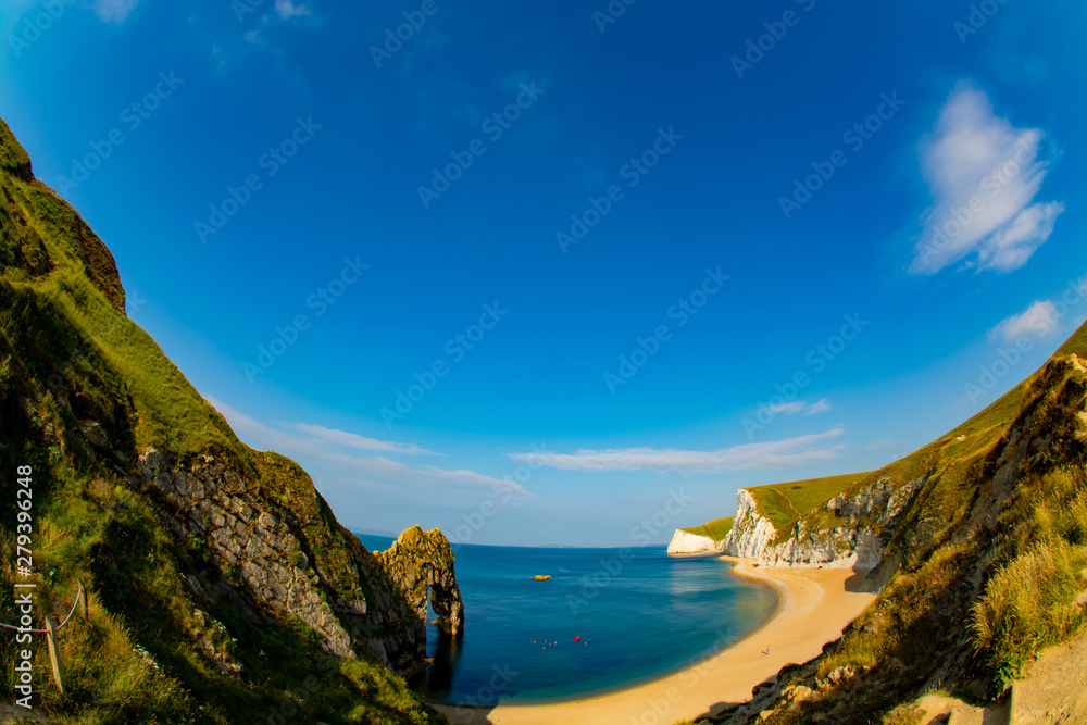 Durdle Door beach with the rock and white cliffs visible in super wide angle