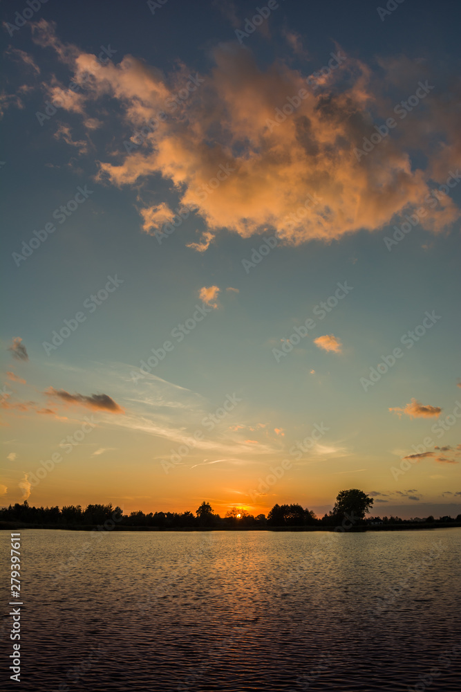 Cloud highlighted by the sun over the water at sunset Cloud highlighted by the sun over the water at sunset