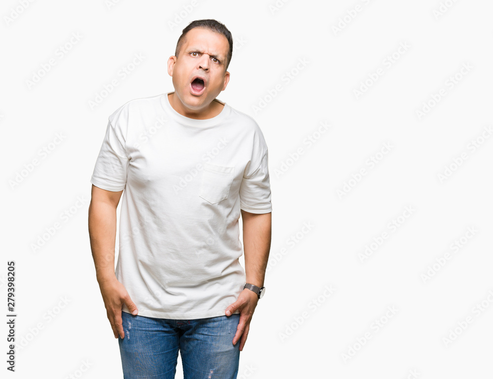 Middle age arab man wearig white t-shirt over isolated background In shock face, looking skeptical and sarcastic, surprised with open mouth Middle age arab man wearig white t-shirt over isolated background In shock face, looking skeptical and sarcastic, surprised with open mouth