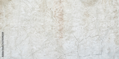 Old gray wall with cracks on the plaster. Abstract background