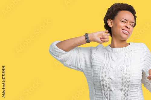Beautiful young african american woman wearing sweater over isolated background stretching back, tired and relaxed, sleepy and yawning for early morning