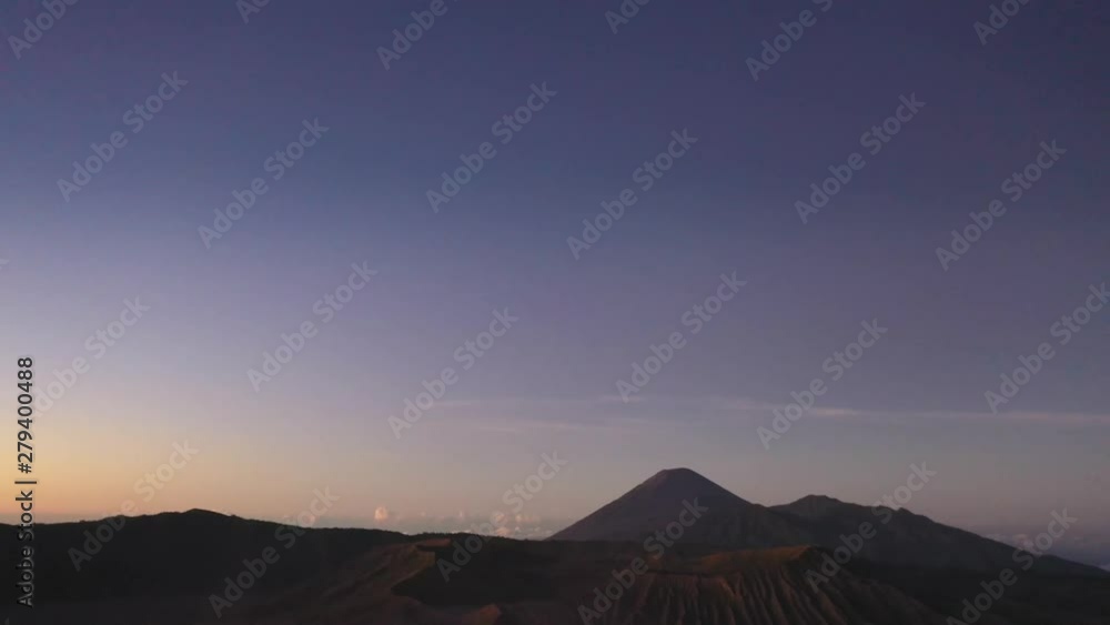 Aerial tilt reverse reveal of a misty volcano at dawn, Bromo, Java Aerial tilt reverse reveal of a misty volcano at dawn, Bromo, Java