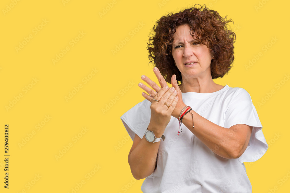 Beautiful middle ager senior woman wearing white t-shirt over isolated background Suffering pain on hands and fingers, arthritis inflammation Beautiful middle ager senior woman wearing white t-shirt over isolated background Suffering pain on hands and fingers, arthritis inflammation