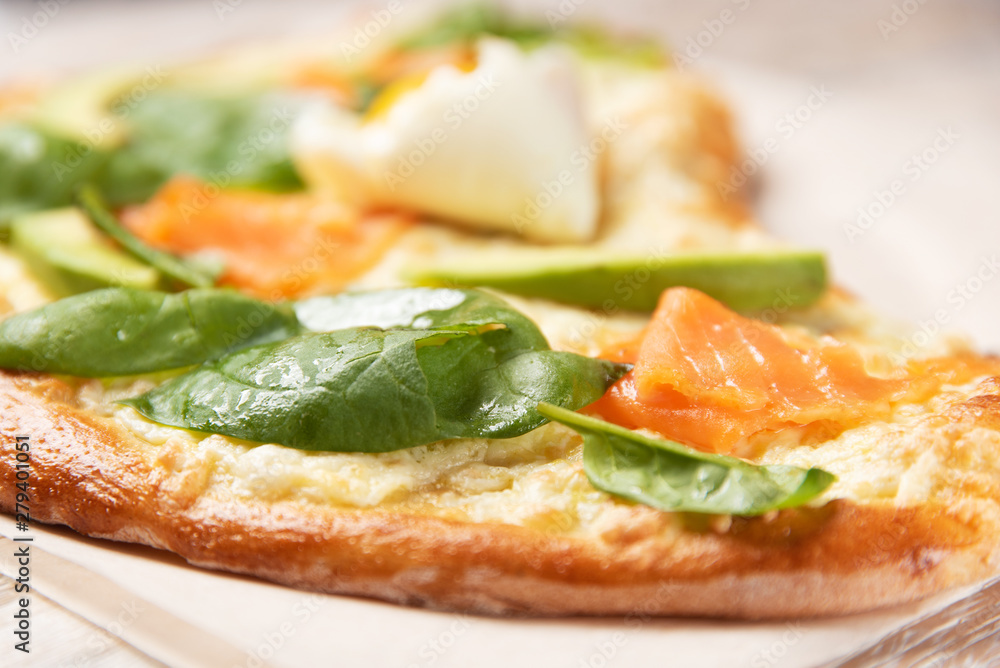 Pizza with salmon close-up in defocus. Pizza with salmon close-up in defocus.
