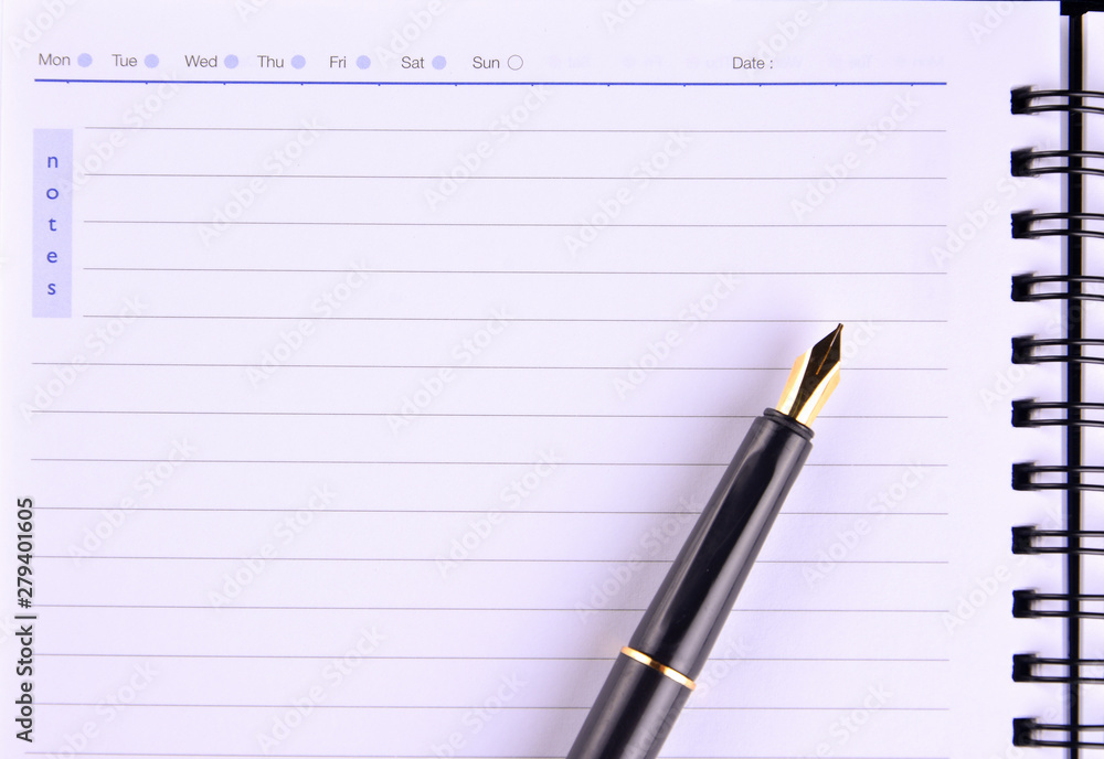 Notebook with fountain pen on wooden table Notebook with fountain pen on wooden table