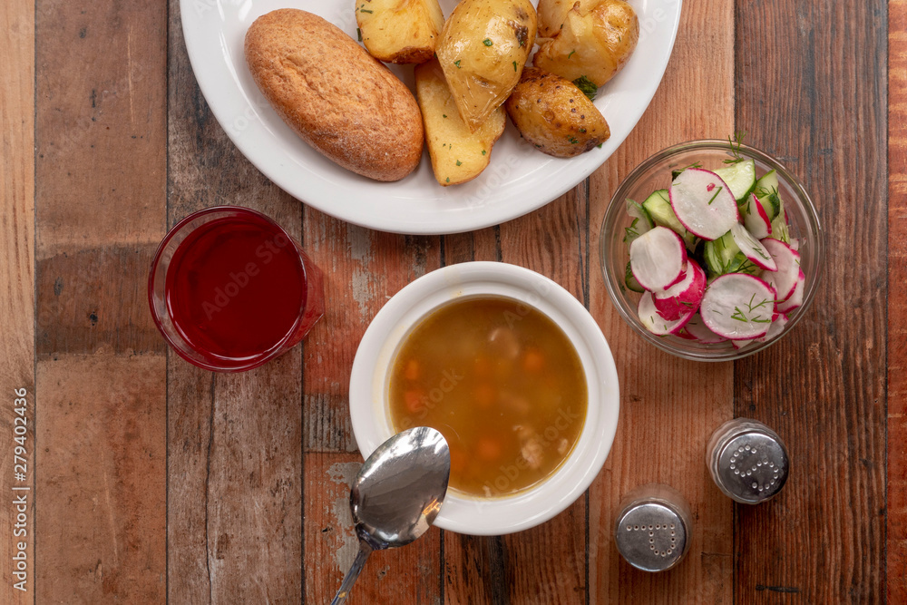 Set lunch, top view. Soup, side dish, salad, compote. Set lunch, top view. Soup, side dish, salad, compote.