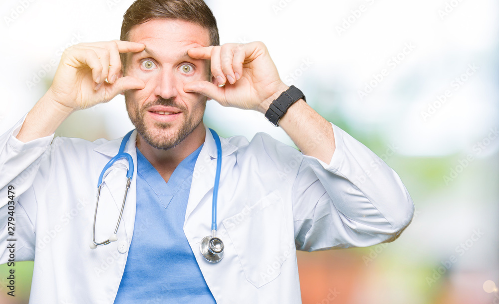 Handsome doctor man wearing medical uniform over isolated background Trying to open eyes with fingers, sleepy and tired for morning fatigue Handsome doctor man wearing medical uniform over isolated background Trying to open eyes with fingers, sleepy and tired for morning fatigue