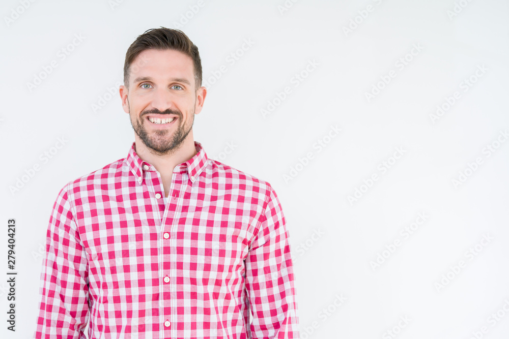 Obraz premium Young handsome man wearing shirt over isolated background with a happy and cool smile on face. Lucky person.