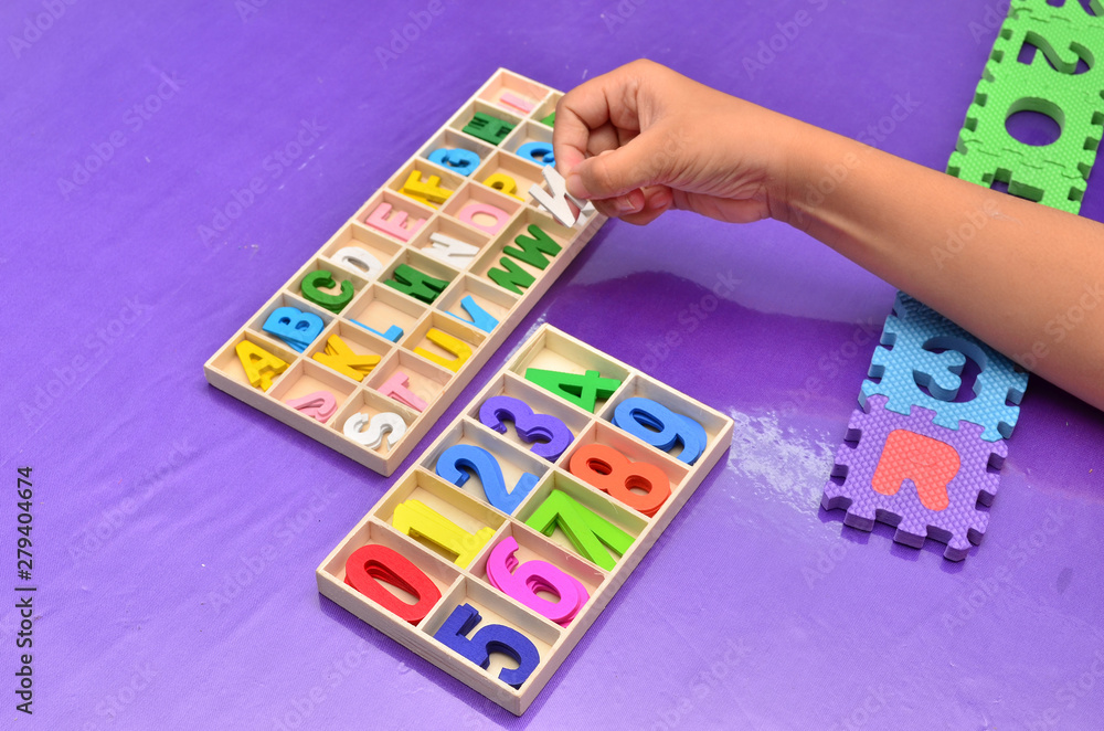 Child's hands playing with alphabet Child's hands playing with alphabet