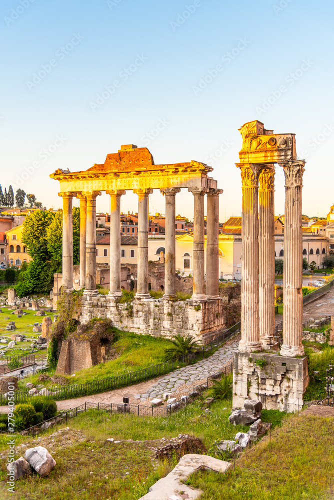 Fototapeta premium Roman Forum with ruins of Temple of Saturn on sunny summer morning. Antique ruins in Rome, Italy