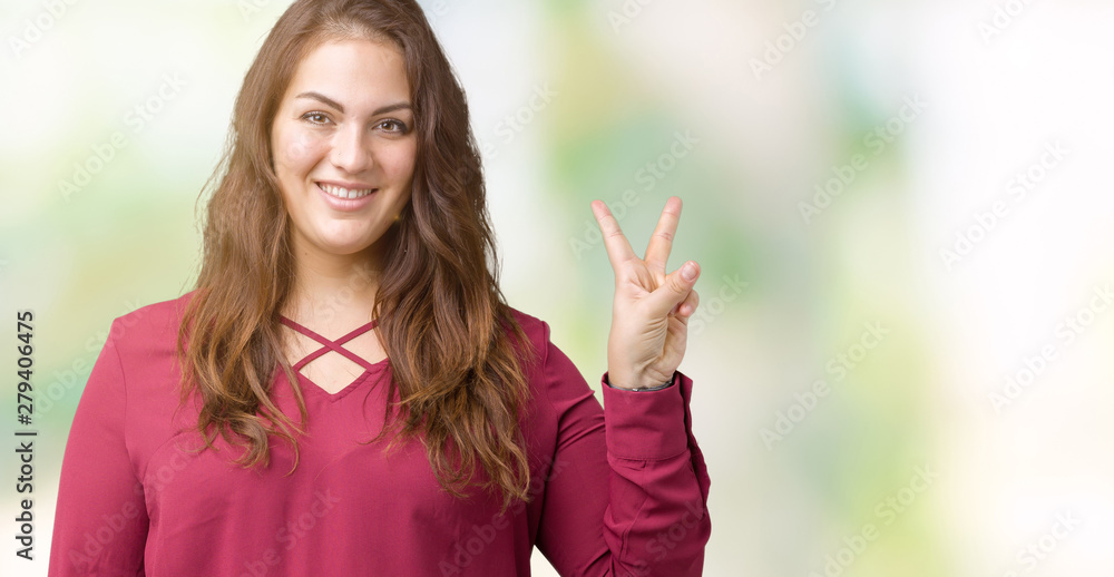 Beautiful plus size young woman over isolated background smiling with happy face winking at the camera doing victory sign. Number two. Beautiful plus size young woman over isolated background smiling with happy face winking at the camera doing victory sign. Number two.