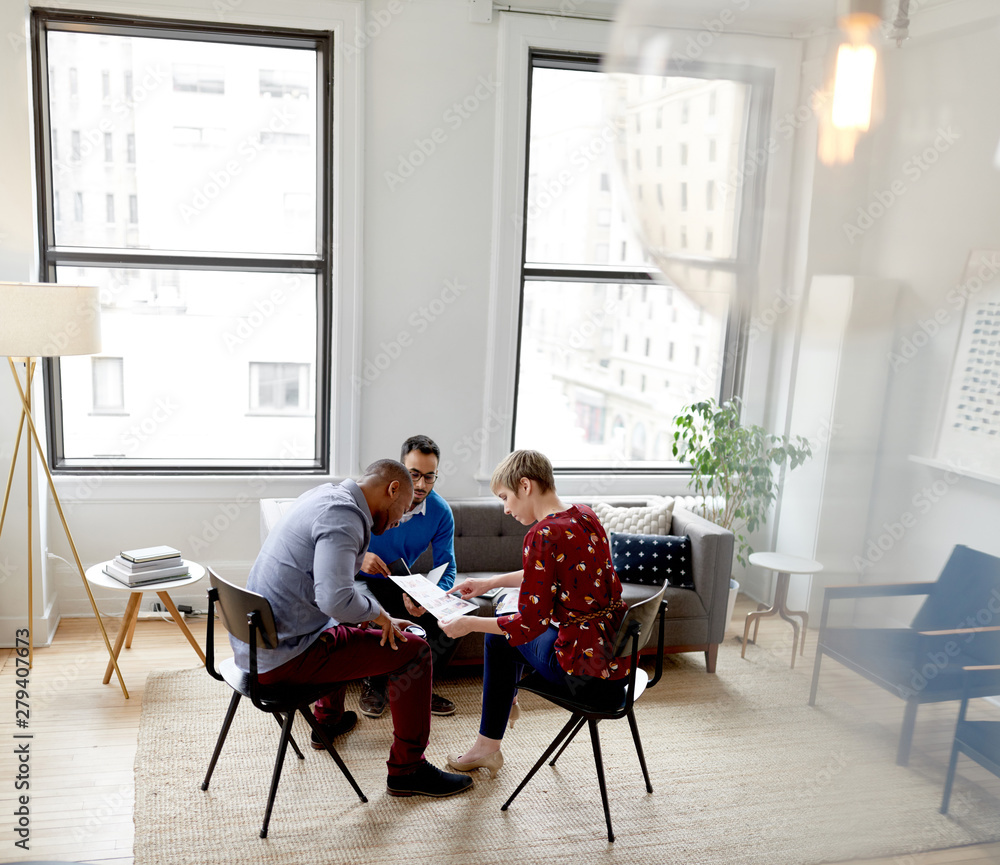 Multi-ethnic team of creative millenials collaborating on a brainstorm project Multi-ethnic team of creative millenials collaborating on a brainstorm project