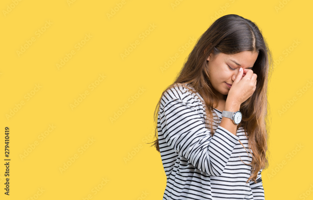 Young beautiful brunette woman wearing stripes sweater over isolated background tired rubbing nose and eyes feeling fatigue and headache. Stress and frustration concept. Young beautiful brunette woman wearing stripes sweater over isolated background tired rubbing nose and eyes feeling fatigue and headache. Stress and frustration concept.