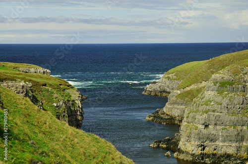 Turbulant sea at entrance to Smoo Cove photo