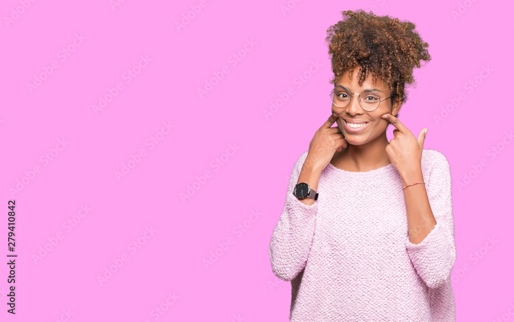 Beautiful young african american woman wearing glasses over isolated background Smiling with open mouth, fingers pointing and forcing cheerful smile Beautiful young african american woman wearing glasses over isolated background Smiling with open mouth, fingers pointing and forcing cheerful smile