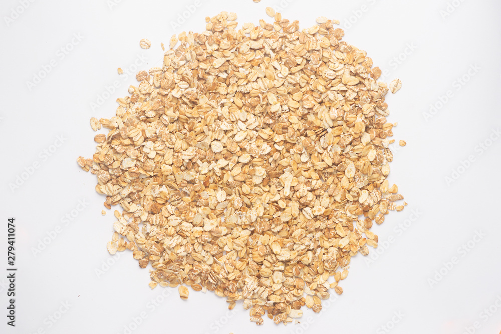 Cereal flakes for granola closeup. Flakes isolated on white background. Nutrition concept. Cereal flakes stock photo. Cereal flakes for granola closeup. Flakes isolated on white background. Nutrition concept. Cereal flakes stock photo.
