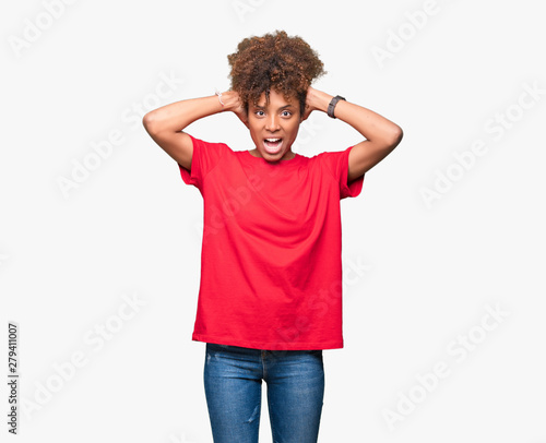 Beautiful young african american woman over isolated background Crazy and scared with hands on head, afraid and surprised of shock with open mouth