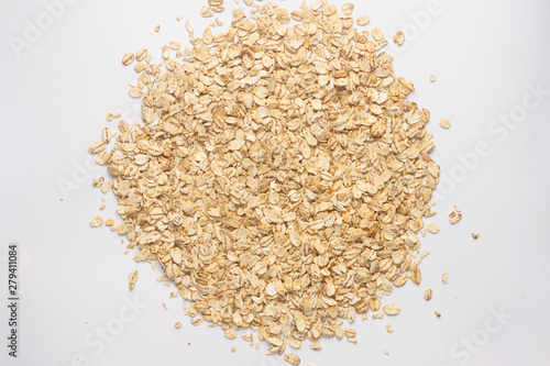 Cereal flakes for granola closeup. Flakes isolated on white background. Nutrition concept. Cereal flakes stock photo.
