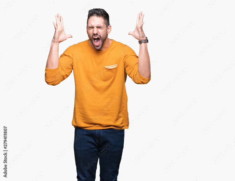 Fototapeta premium Young handsome man over isolated background celebrating mad and crazy for success with arms raised and closed eyes screaming excited. Winner concept