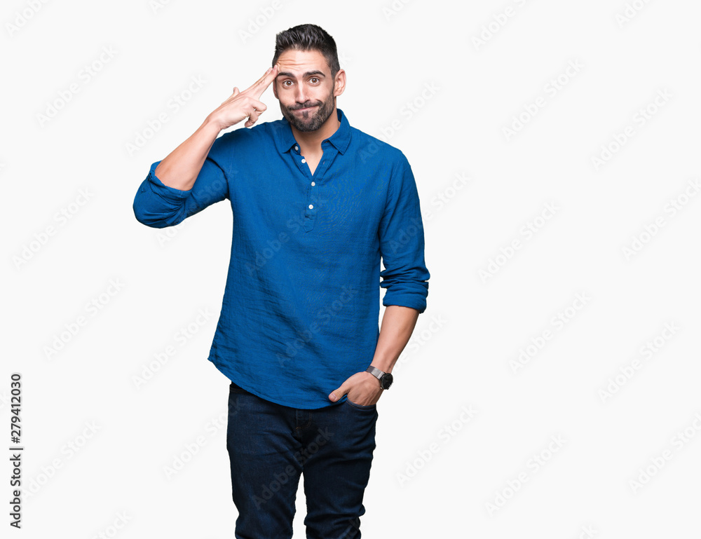 Fototapeta premium Young handsome man over isolated background Shooting and killing oneself pointing hand and fingers to head, suicide gesture.