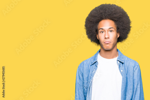 Young african american man with afro hair depressed and worry for distress, crying angry and afraid. Sad expression.