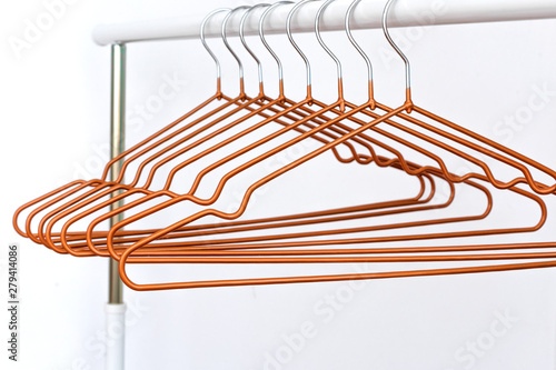 Empty metal cloth hangers on white background minimalism style. Empty hangers in a fashion store.