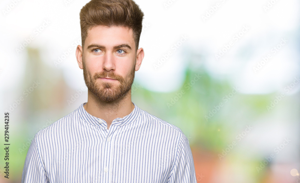 Young handsome man smiling looking side and staring away thinking. Young handsome man smiling looking side and staring away thinking.