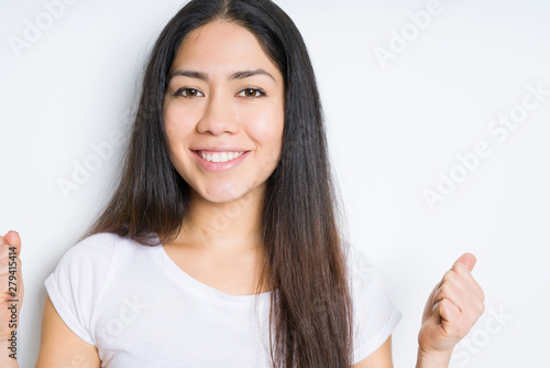 Wallpaper Mural Beautiful brunette woman over isolated background celebrating surprised and amazed for success with arms raised and open eyes. Winner concept. Torontodigital.ca