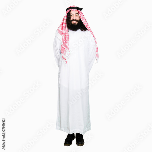 Arabian business man with long hair wearing traditional keffiyeh scarf with a happy and cool smile on face. Lucky person.
