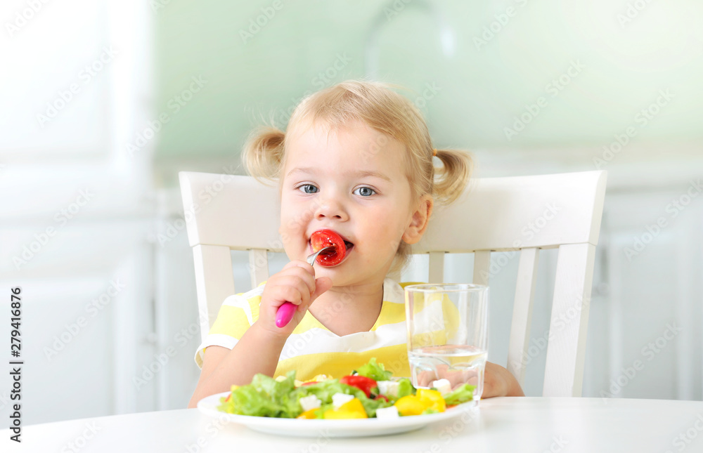 little girl eating healthy food in the kitchen,kid have a meal,child with vegetables little girl eating healthy food in the kitchen,kid have a meal,child with vegetables