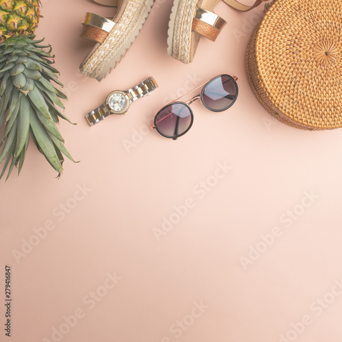 Summer background with wicker fashion bag, and women's summer shoes, pineapple and sun glasses, watches