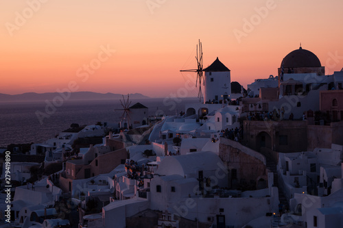 The white village of Oia, on the island of Santorini, Greece during a romantic orange sunset in the evening.