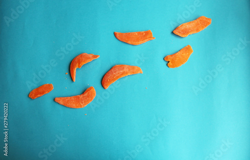 dried fruits mango orange slice on blue bright background. Tasty yummy dieting photo