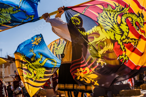 Obraz na płótnie Valencia, Spain- January 27, 2019: Italian Flags-wavers, Sbandieratori, performing the traditional and antique dance by throwing flags in the air, during a medieval festival
