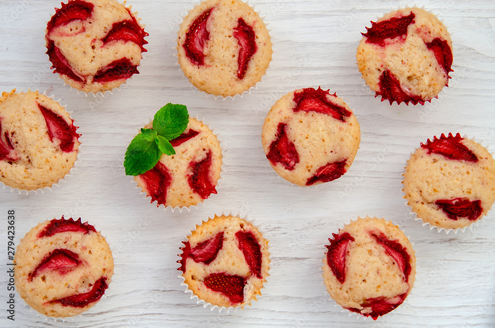 Strawberry muffins, close white background with mint