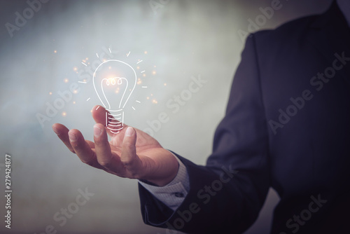 businessman holding icon light bulb,idea concept,,Presenting new ideas.