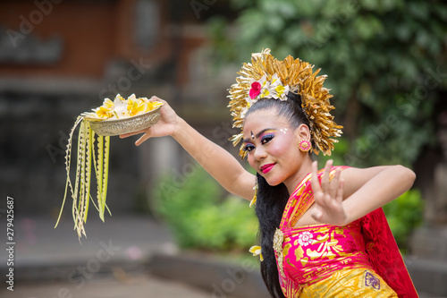 Balinese pendet dancer dancing with flower photo