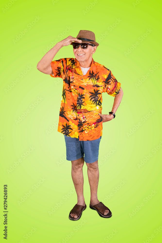 Elderly traveler looking far away in the studio Elderly traveler looking far away in the studio