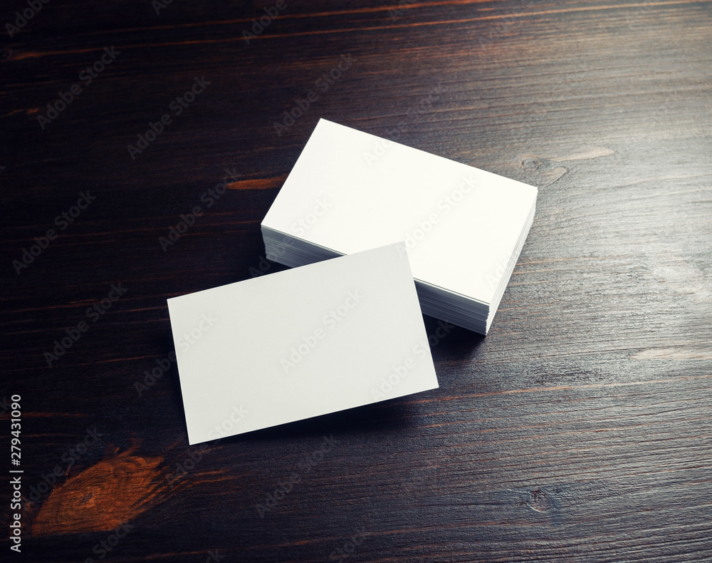 Photo of blank white business cards on dark wooden background. Photo of blank white business cards on dark wooden background.