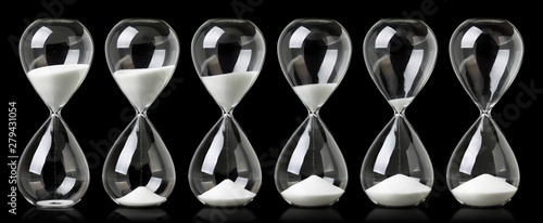 Collection of hourglasses with white sand showing the passage of time